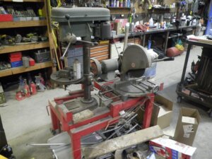 table with drill press, chop saw and double grinder-image