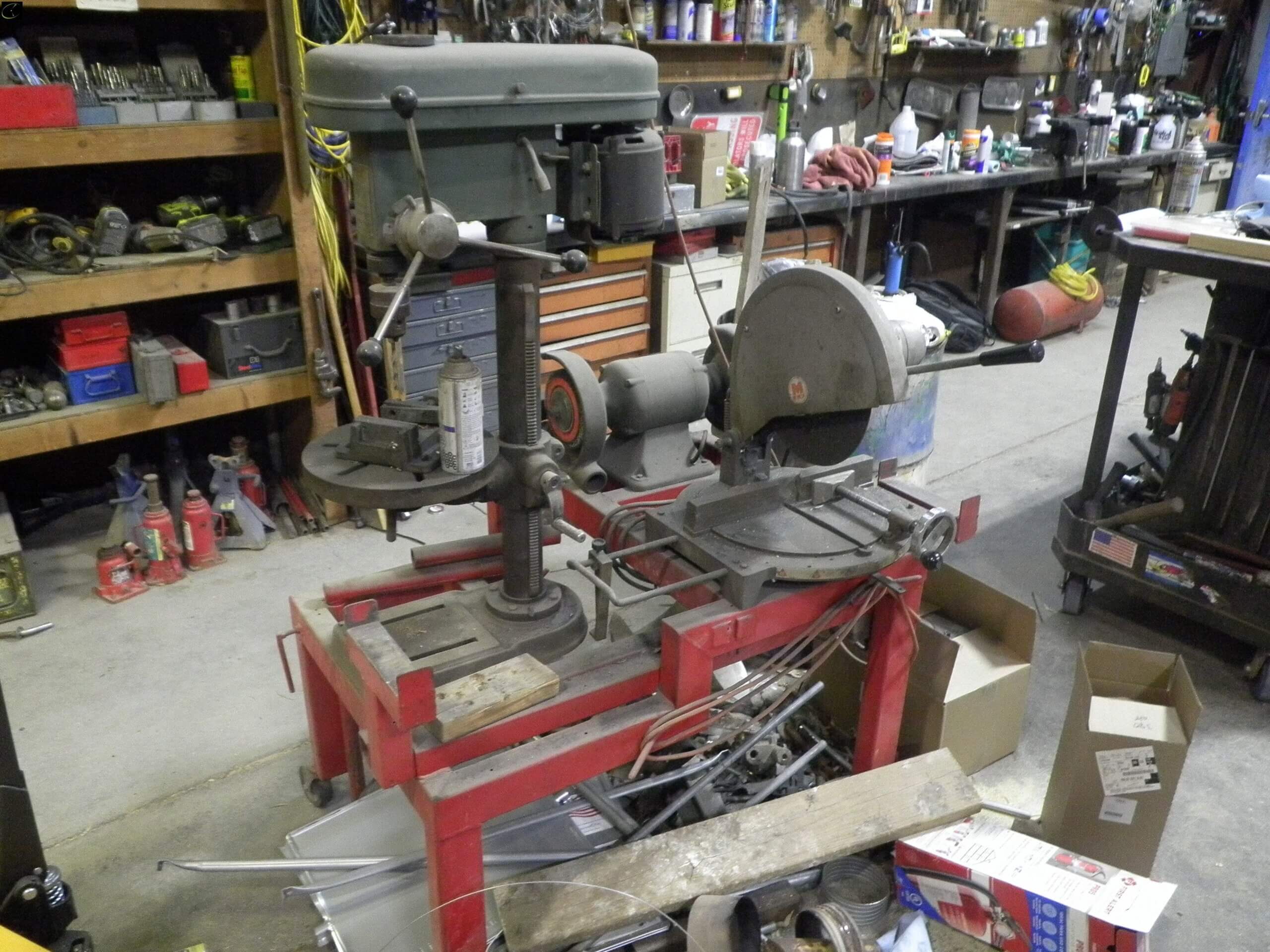 table with drill press, chop saw and double grinder-image